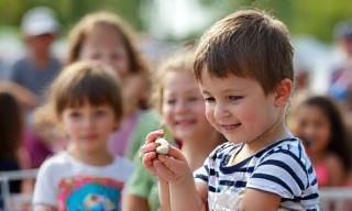 Children and families enjoying activities at a Community Dairy Day event.
