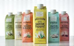A display of Warrnambool Dairy Foods' new certified organic milk range in various packaging.