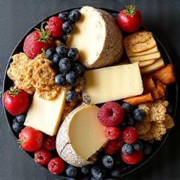 User-generated content example: an artistic and inviting cheese platter featuring various Warrnambool cheeses, fruits, and crackers.